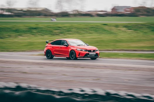 pexels-photo-16368798-16368798 A red Honda Civic Type R speeding on an outdoor race track in Blyton, England.
